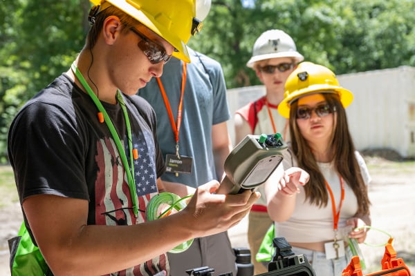 Explosives campers look at detonator